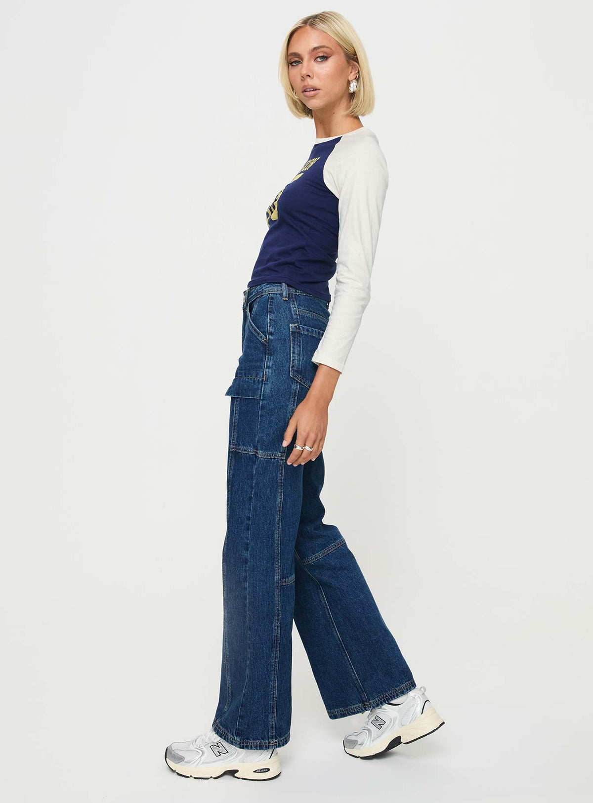side view of model wearing Princess Polly Chad High Rise Wide Leg Cargo Jeans Dark Wash Denim Mid Rise Jeans Jeans 