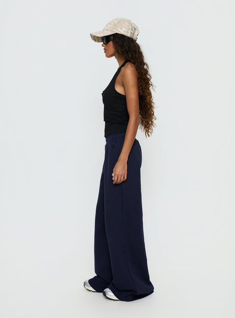 side view of model wearing Princess Polly Summits Flared Track Pants Navy Mid Rise Pants Pants 