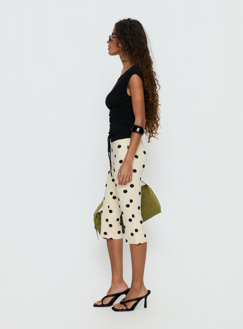 side view of model wearing Princess Polly Samaira Capri Pant Cream Polka Dot Mid Rise Pants Pants 