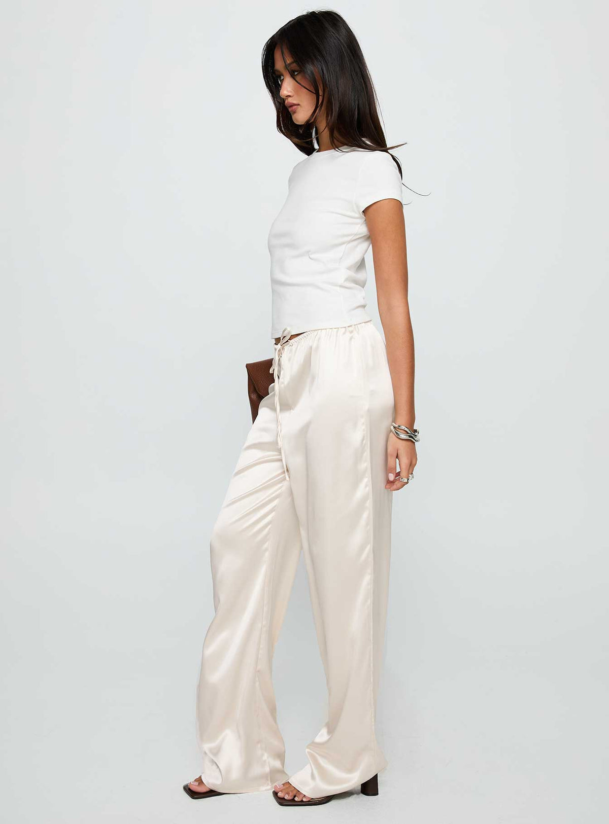 side view of model wearing Princess Polly Soulstar Satin Pants Champagne Low Rise Pants 