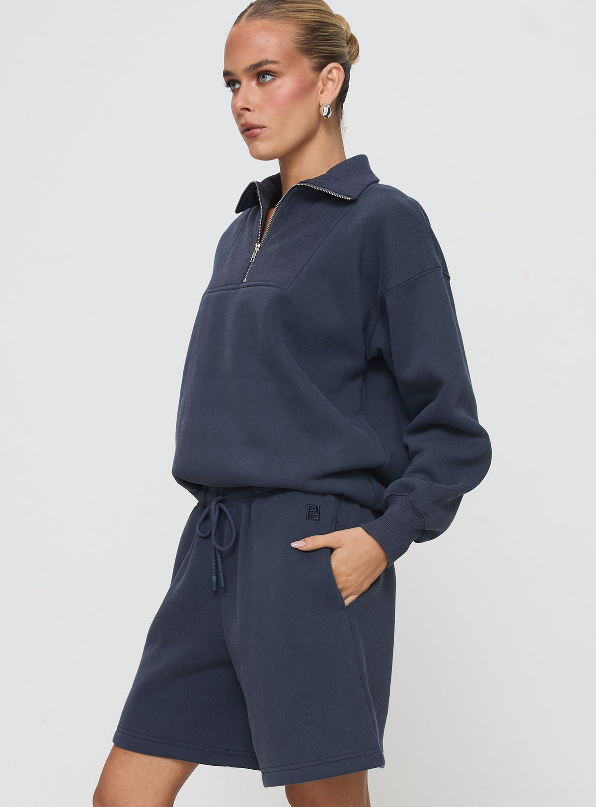 side view of model wearing Princess Polly Dream Fleece Quarter Zip Sweatshirt Navy Jumpers 