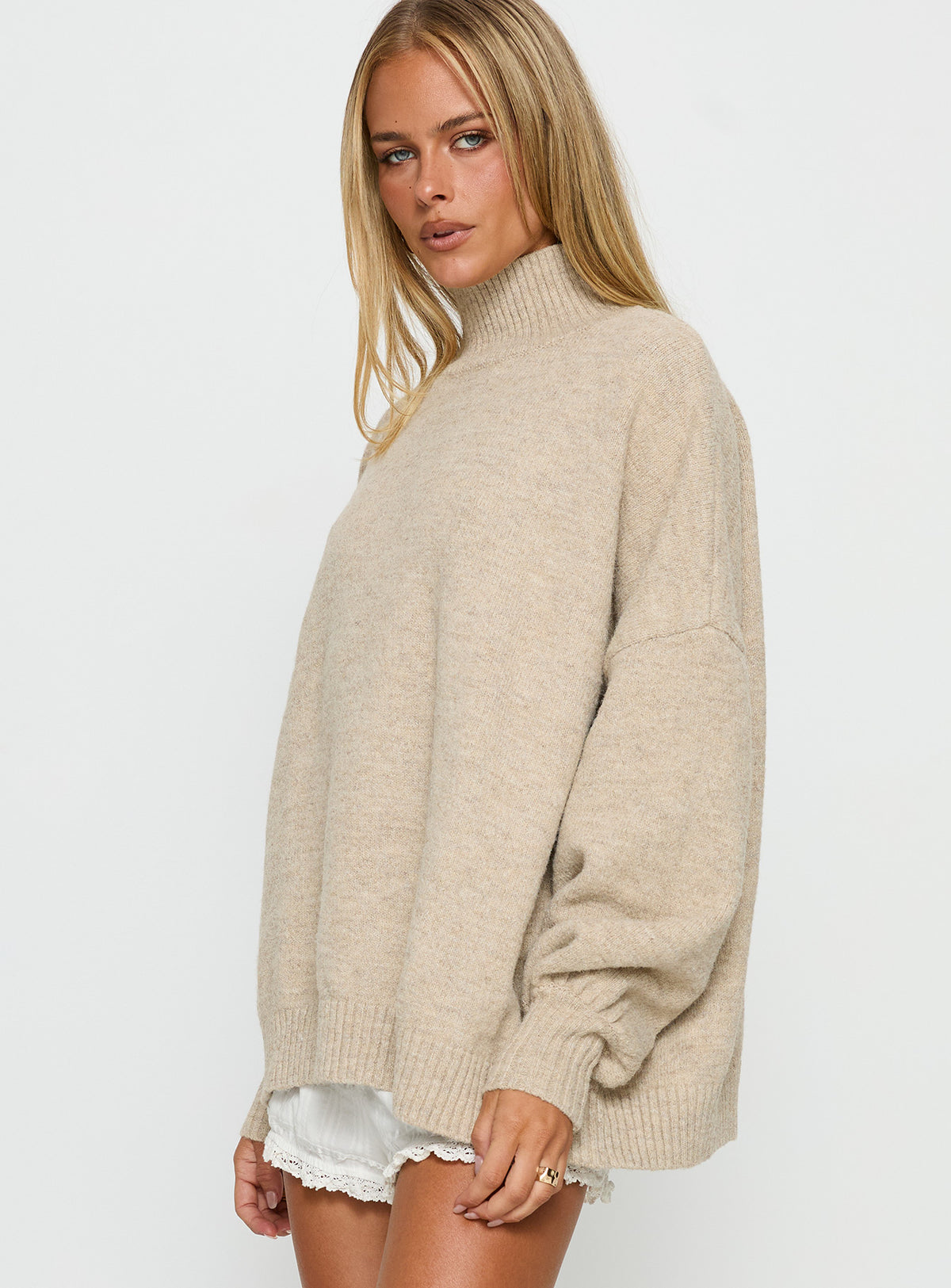 side view of model wearing Princess Polly Patrizia Funnel Neck Knit Sweater Beige Jumpers 