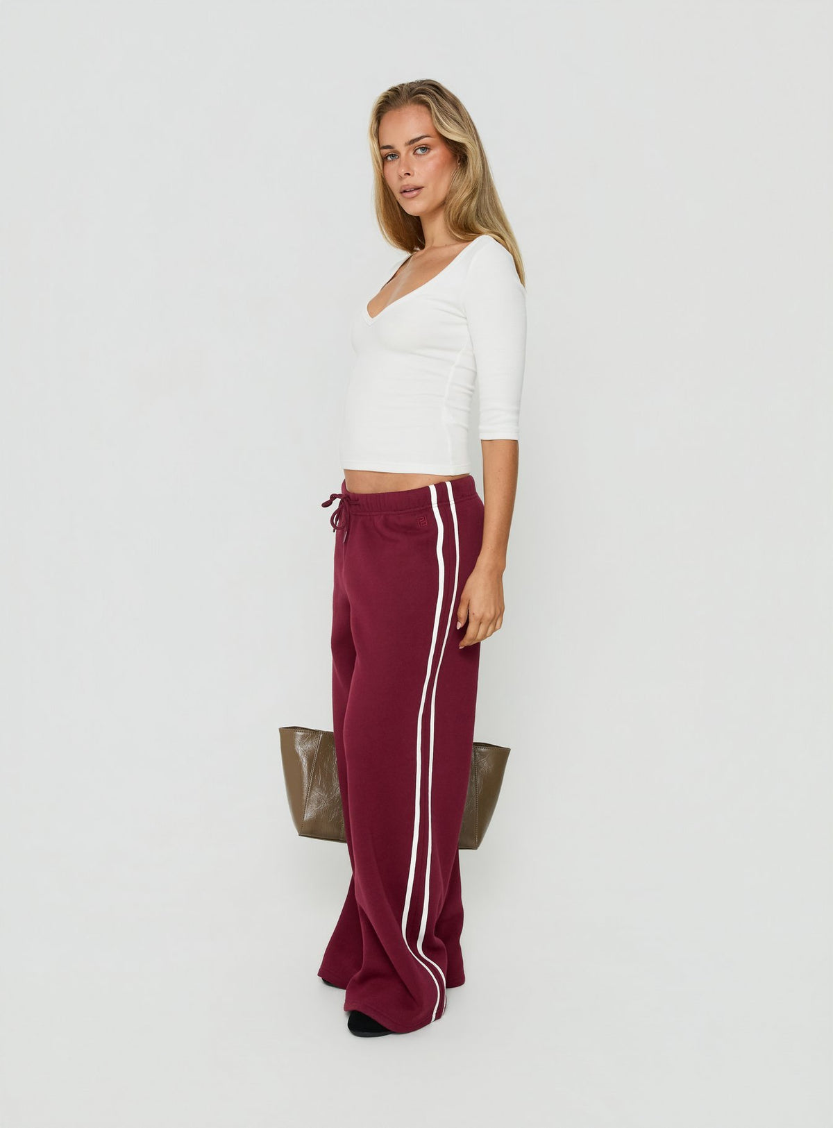 Crafted from cherry fabric, the Kennah Wide Leg Sweat Pants in womens-regular-pants with mid-rise waist front view of model wearing Princess Polly