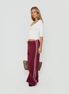 Crafted from cherry fabric, the Kennah Wide Leg Sweat Pants in womens-regular-pants with mid-rise waist front view of model wearing Princess Polly