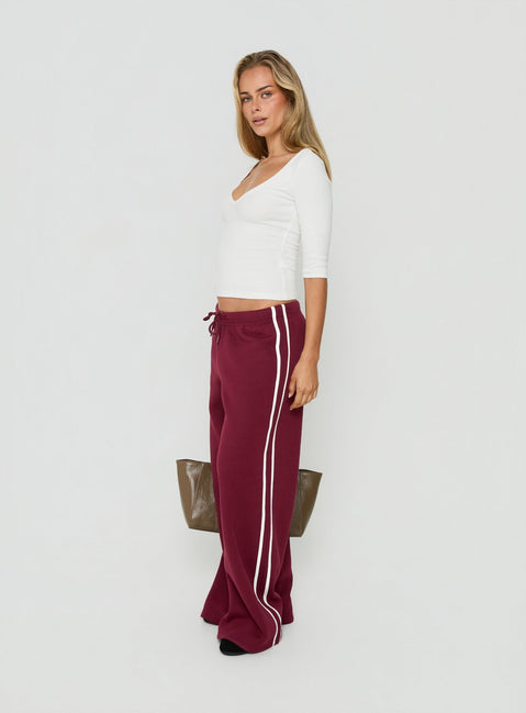 Crafted from cherry fabric, the Kennah Wide Leg Sweat Pants in womens-regular-pants with mid-rise waist front view of model wearing Princess Polly