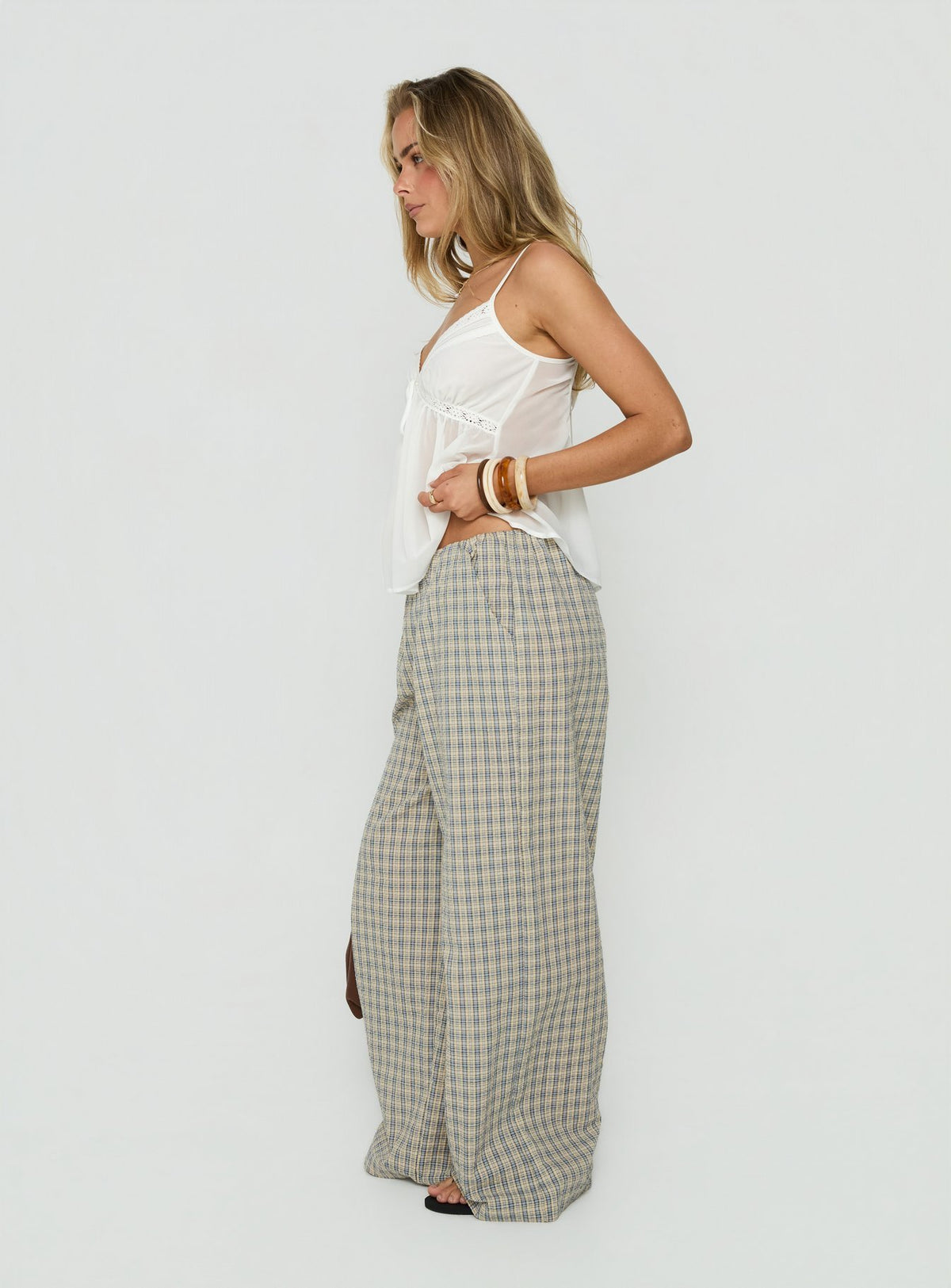 Featuring Lunea Concealed Waistband Pants Multi Check womens-regular-pants with high-rise in checkered wide-leg side view of model wearing Princess Polly