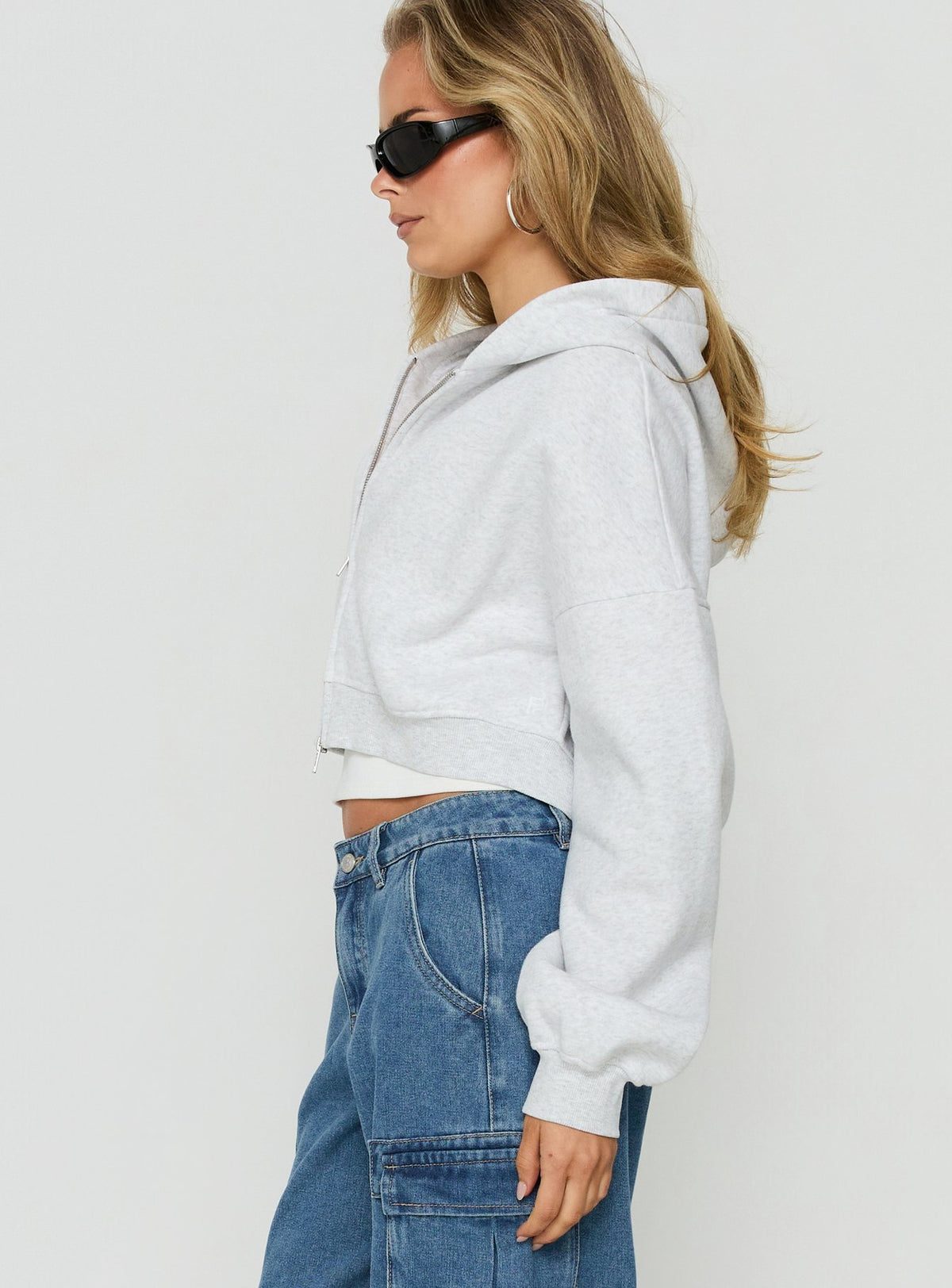 Styled in the Zellah Double Ended Zipper Hoodie Grey Marle womens-jumpers with short length side view of model wearing Princess Polly