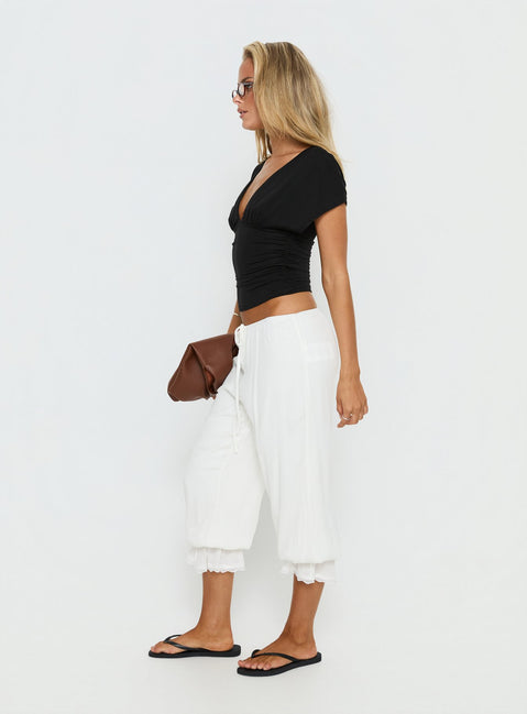 side view of model wearing Princess Polly Basma Bloomer Trouser Pants Rayon White Mid Rise Pants Pants 