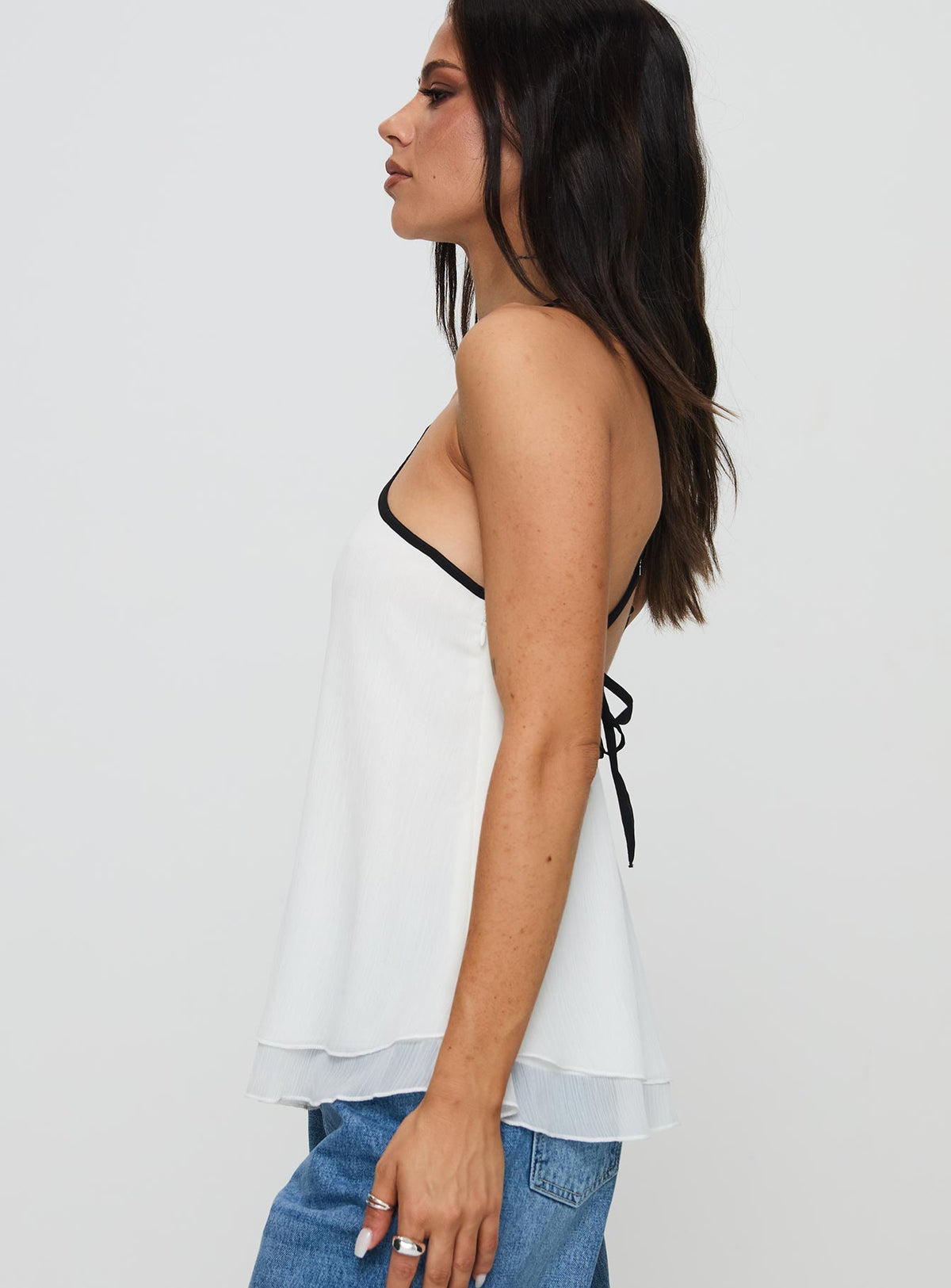 side view of model wearing Princess Polly Rafaella Halter Top Cream Sleeveless Asymmetric Neckline 