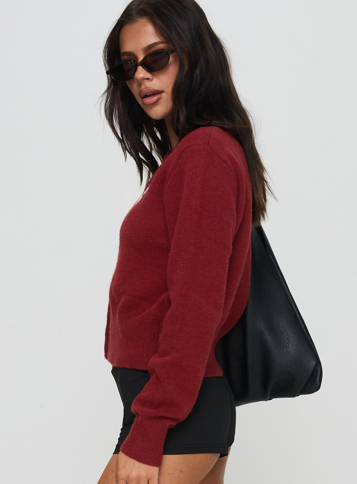 side view of model wearing Princess Polly With A Bow Cardigan Red Jumpers 