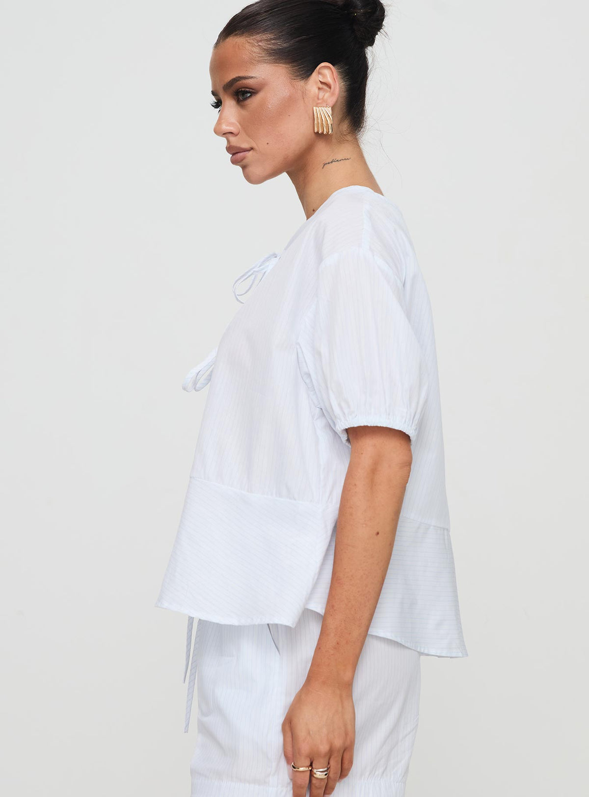 side view of model wearing Princess Polly Sunblind Top White Half Sleeves Crew Neck 