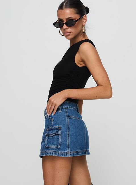   side view of model wearing Princess Polly Pacific Coast Denim Cargo Skirt Dark Wash Mini Skirts Skirts 