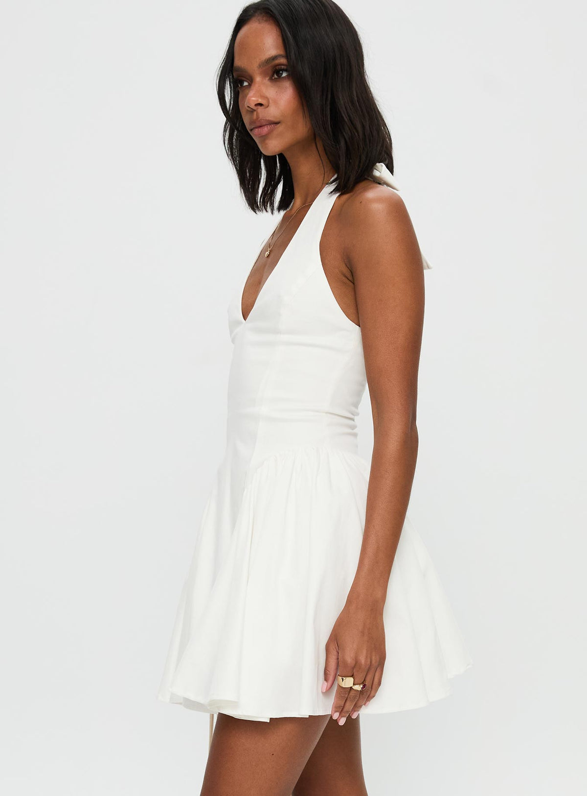 side view of model wearing Princess Polly Karisse Halter Mini Dress White Plunger 
