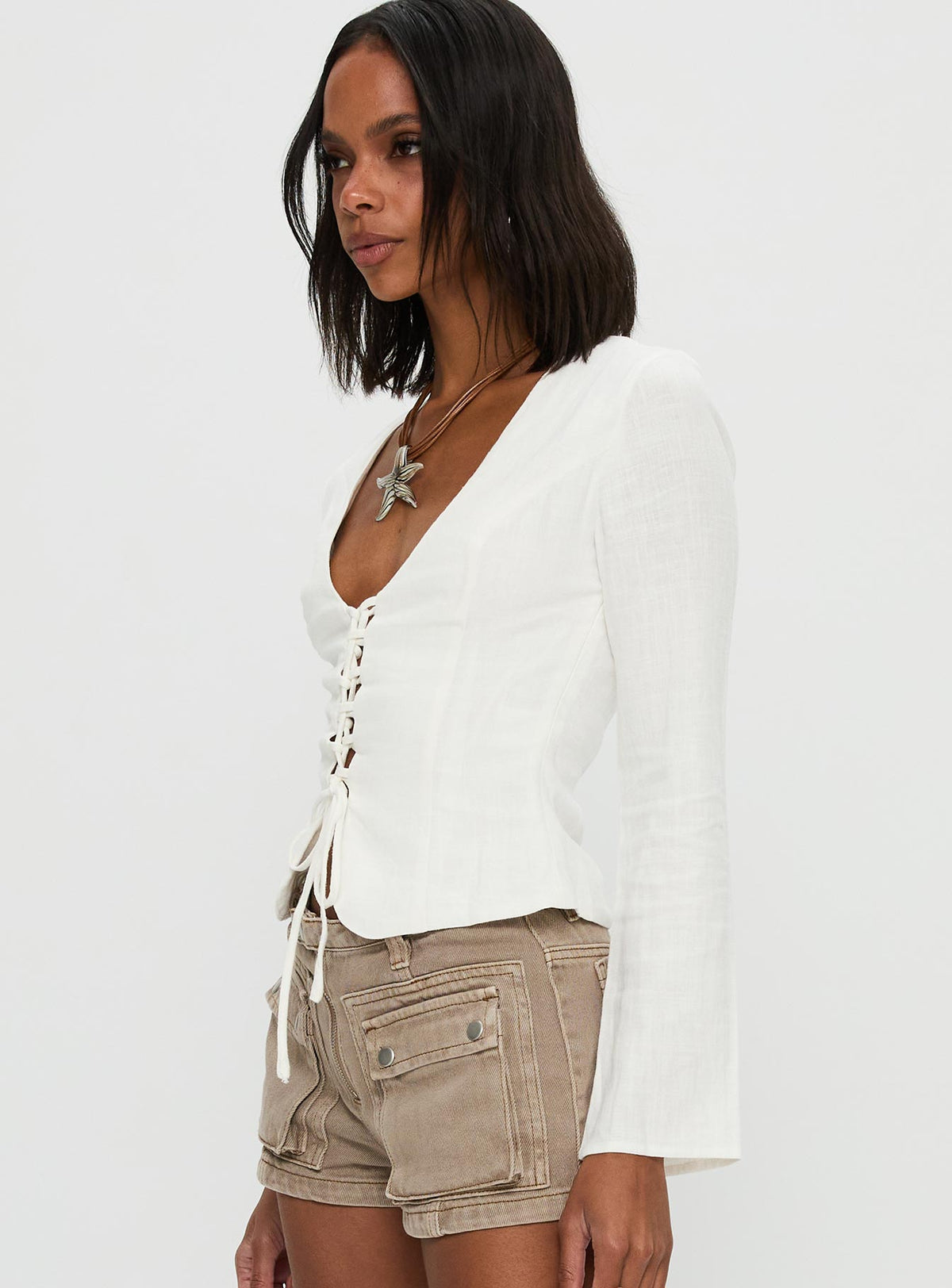side view of model wearing Princess Polly Clouded Linen Long Sleeve Top White Full Sleeves Plunger 