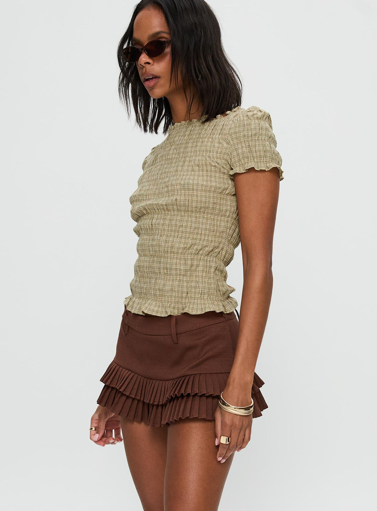 side view of model wearing Princess Polly Deei Double Ruffle Mini Skort Chocolate Low Rise Shorts 