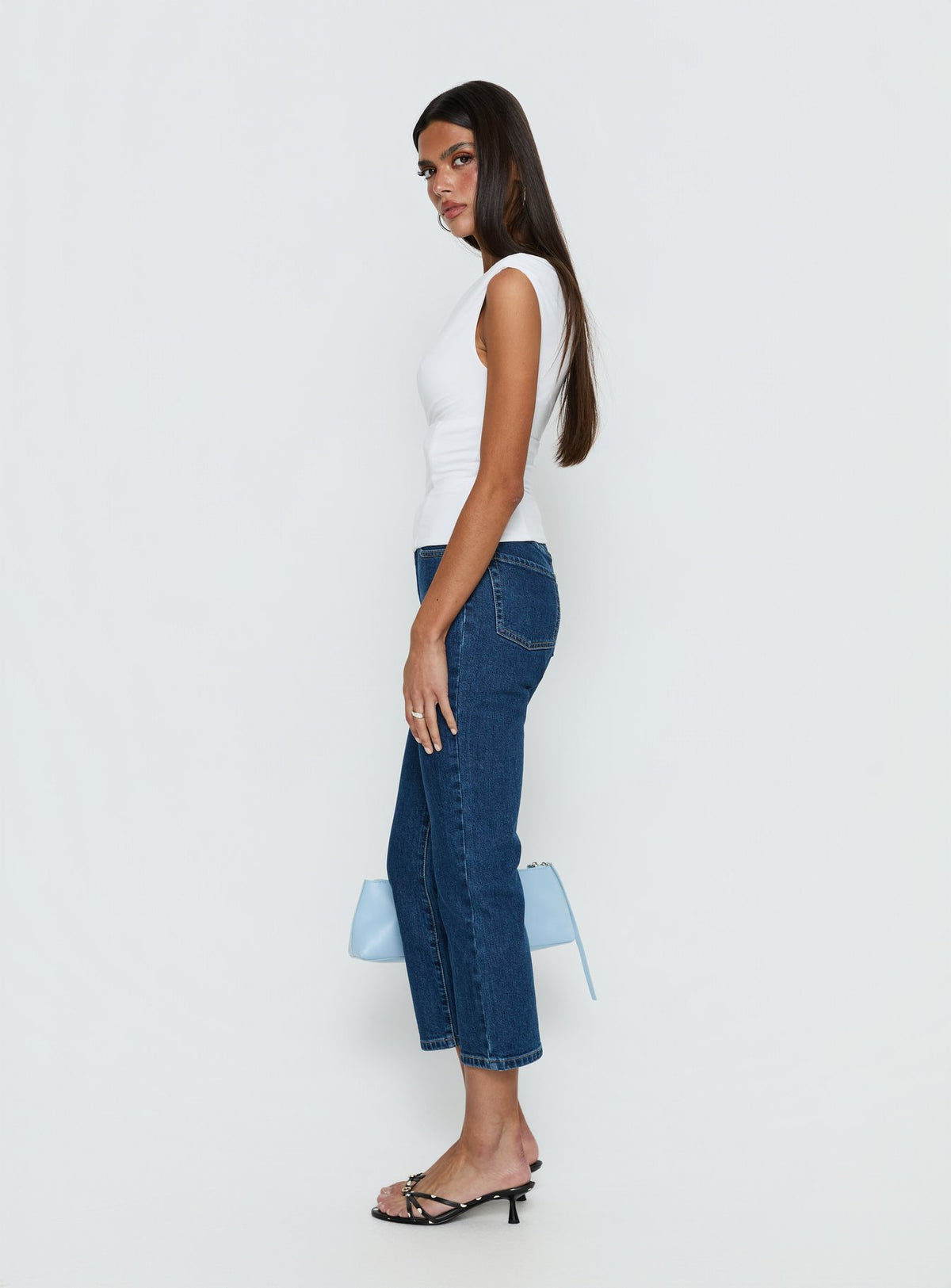 side view of model wearing Princess Polly Cindee High Rise Cropped Jeans Mid Blue Wash High Rise Jeans Jeans 