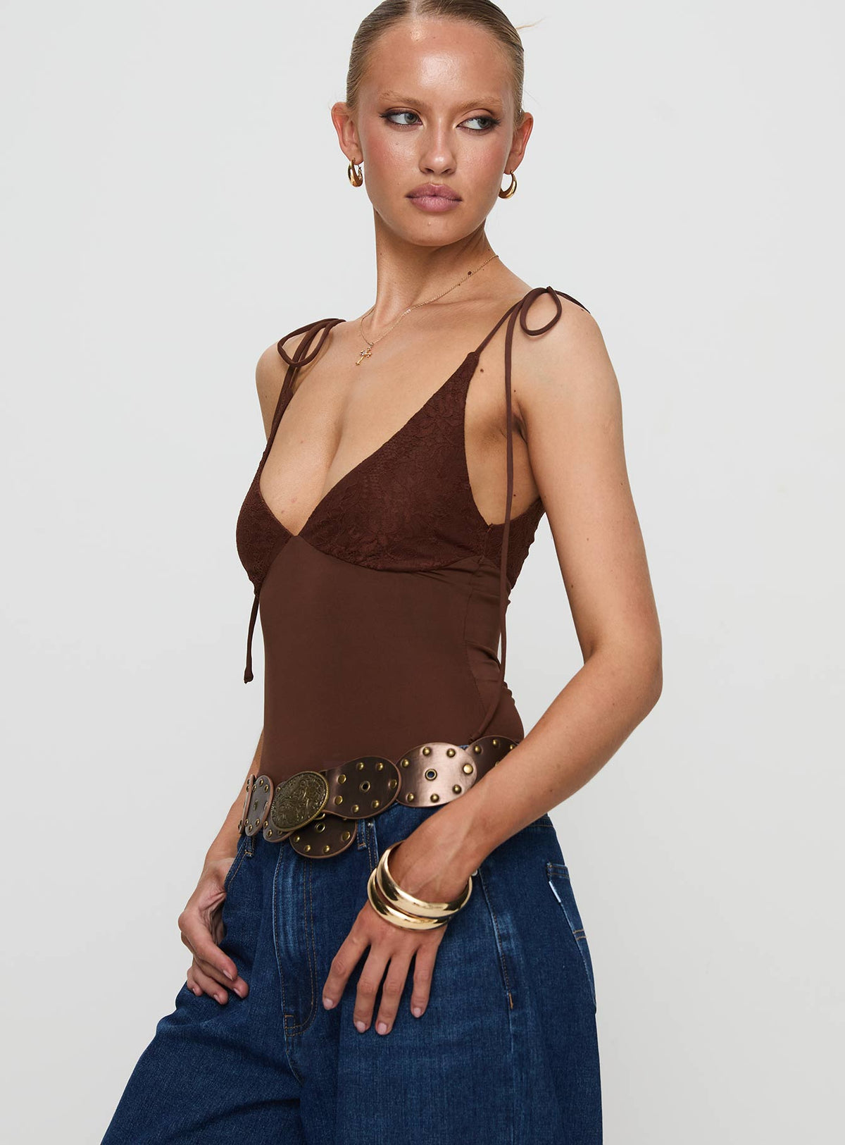 side view of model wearing Princess Polly Prichard Bodysuit Brown Sleeveless Bodysuit 