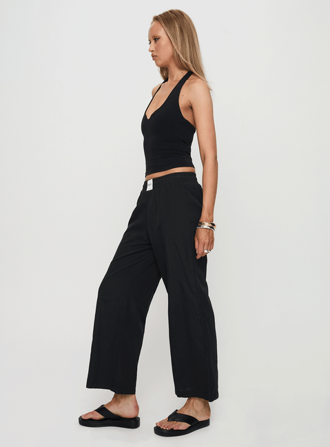 side view of model wearing Princess Polly Beach House Pants Black Low Rise Pants Pants 