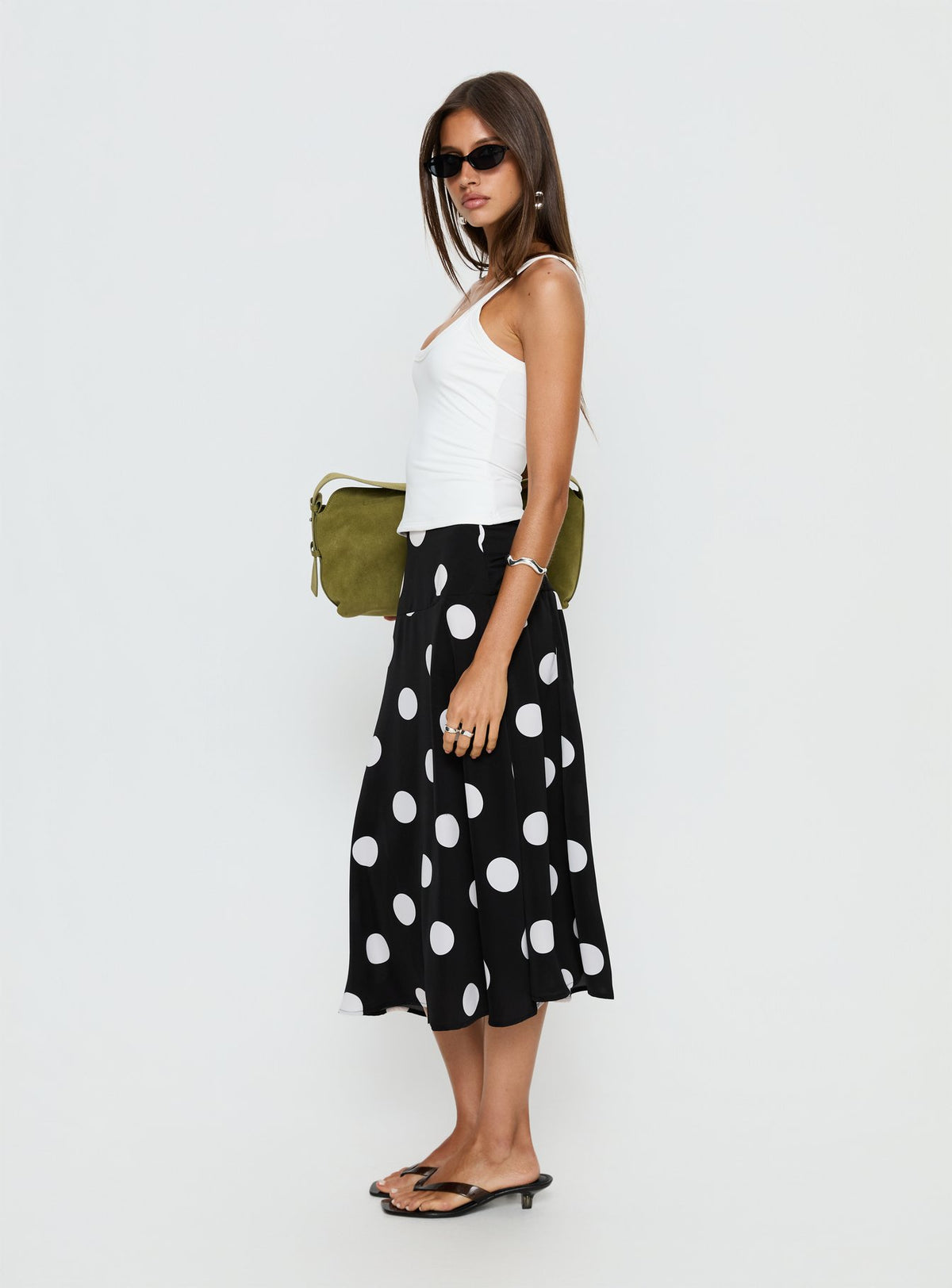   side view of model wearing Princess Polly Picture It Midi Skirt Black Polka Dot Midi Skirts Skirts 