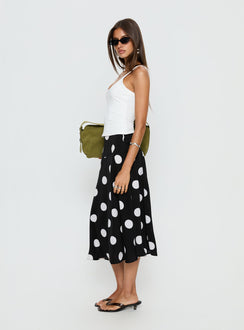   side view of model wearing Princess Polly Picture It Midi Skirt Black Polka Dot Midi Skirts Skirts 