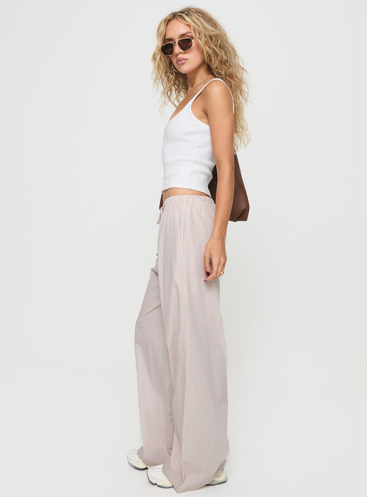 side view of model wearing Princess Polly Ogilvie Pants Beige Stripe Mid Rise Pants Pants 