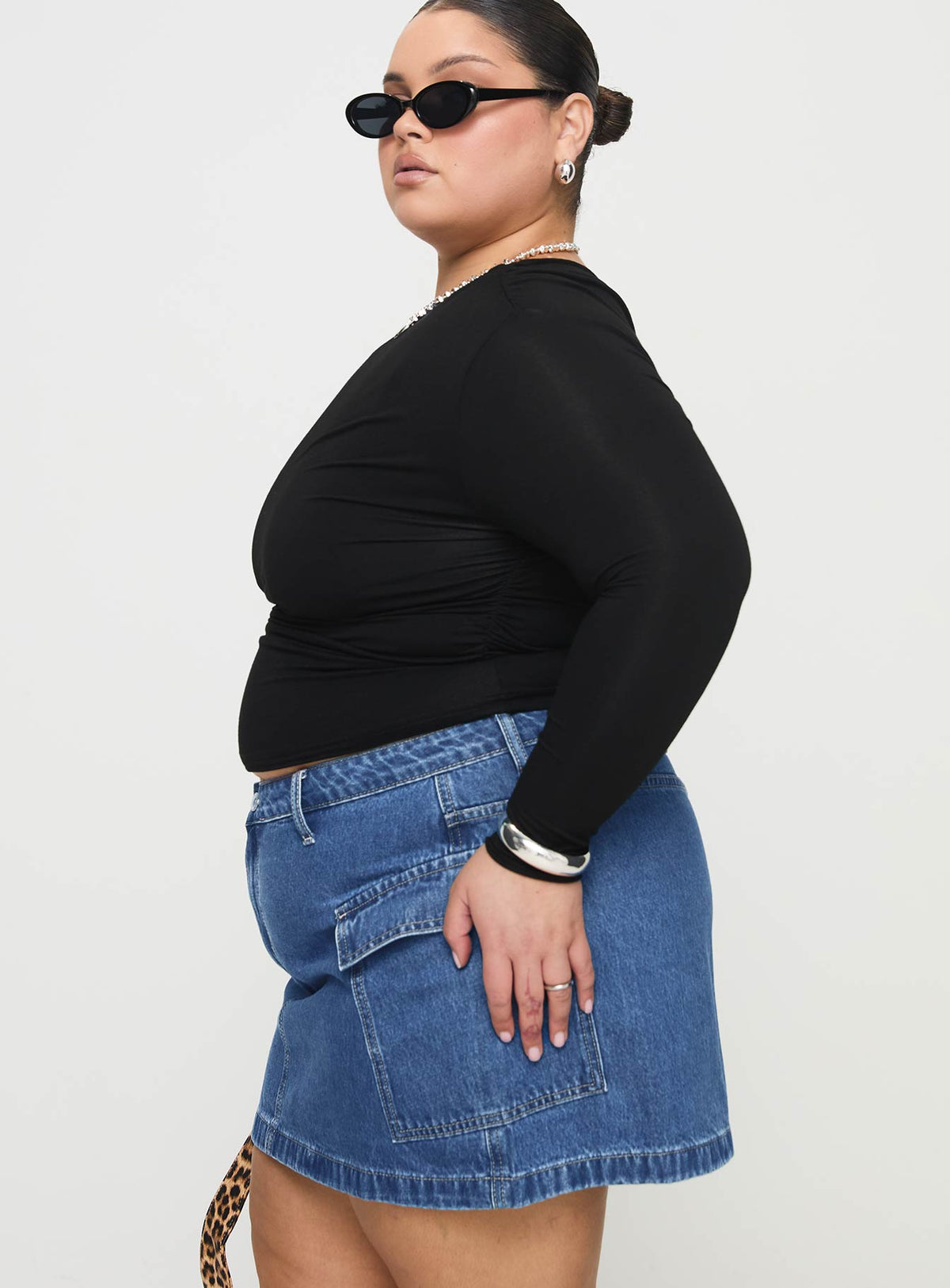   side view of model wearing Princess Polly Zakai Cargo Denim Mini Skirt Mid Blue Curve Mini Skirts Skirts 
