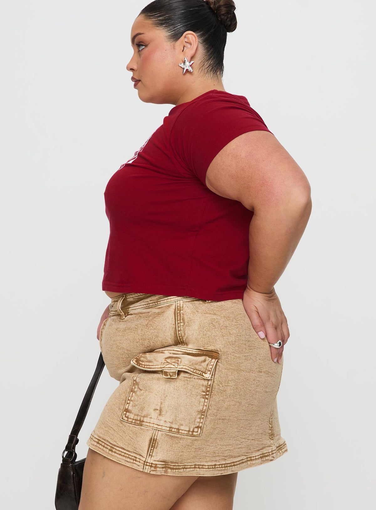   side view of model wearing Princess Polly Velveta Low Rise Denim Skirt Camel Curve Mini Skirts Skirts 