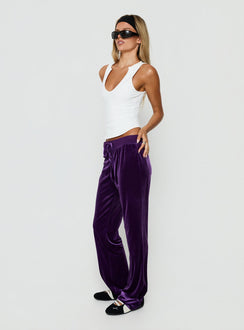 Displaying the Alba Track Pant Plum in womens-regular-pants with mid-rise side view of model wearing Princess Polly