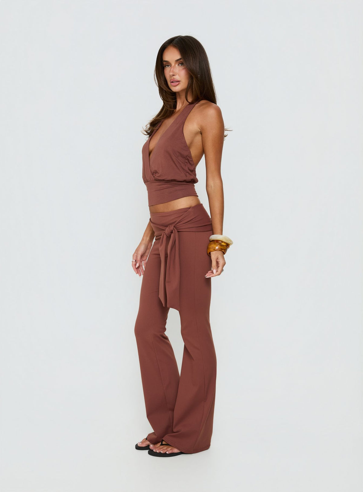 Presenting the Daily Define Tie Waist Pants Brown in womens regular pants with high-rise and wide-leg styling side view of model wearing Princess Polly