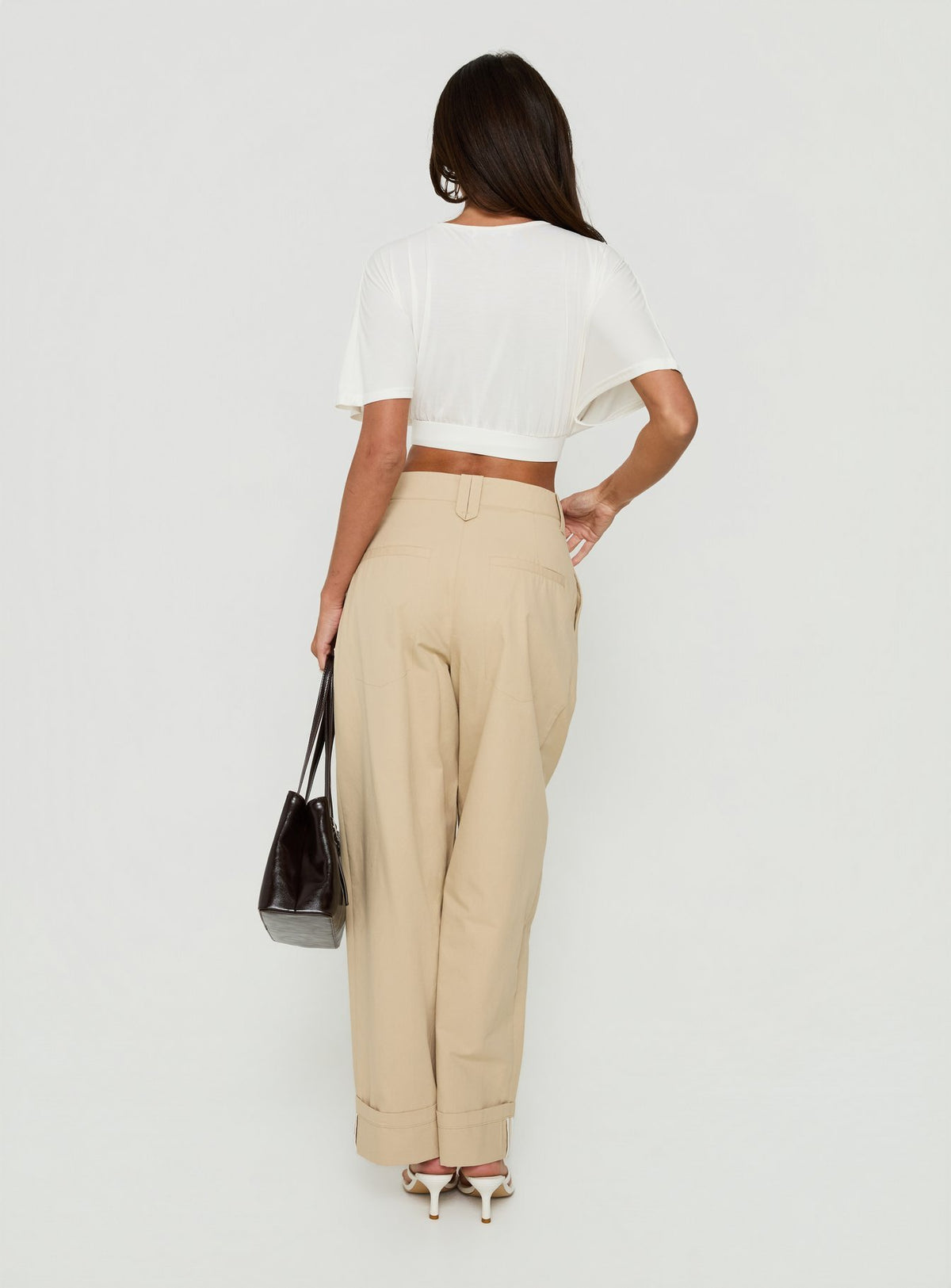 Explore the Kendall Pant Sand womens-regular-pants featuring high-rise pleated wide-leg styling back view of model wearing