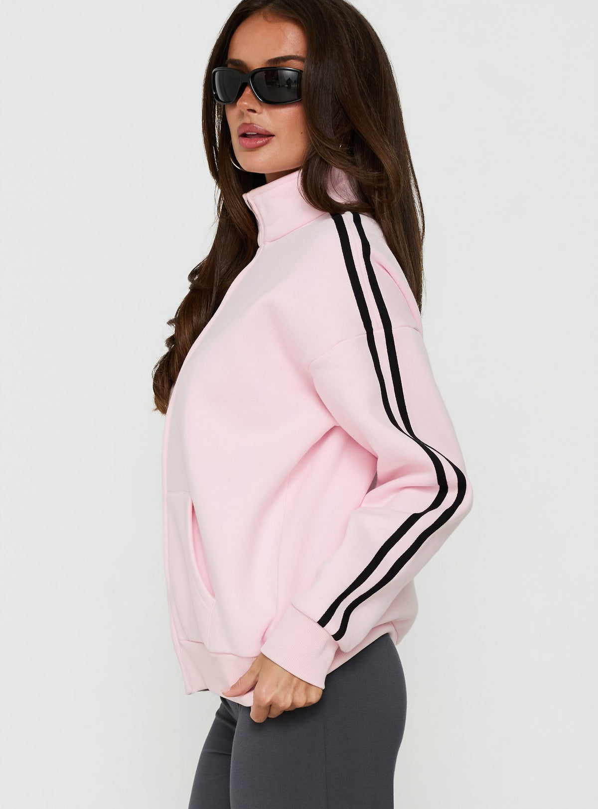 Highlighting the Keeran Funnel Neck Fleece Jumper Pink / Black womens jumpers with long length side view of model wearing Princess Polly