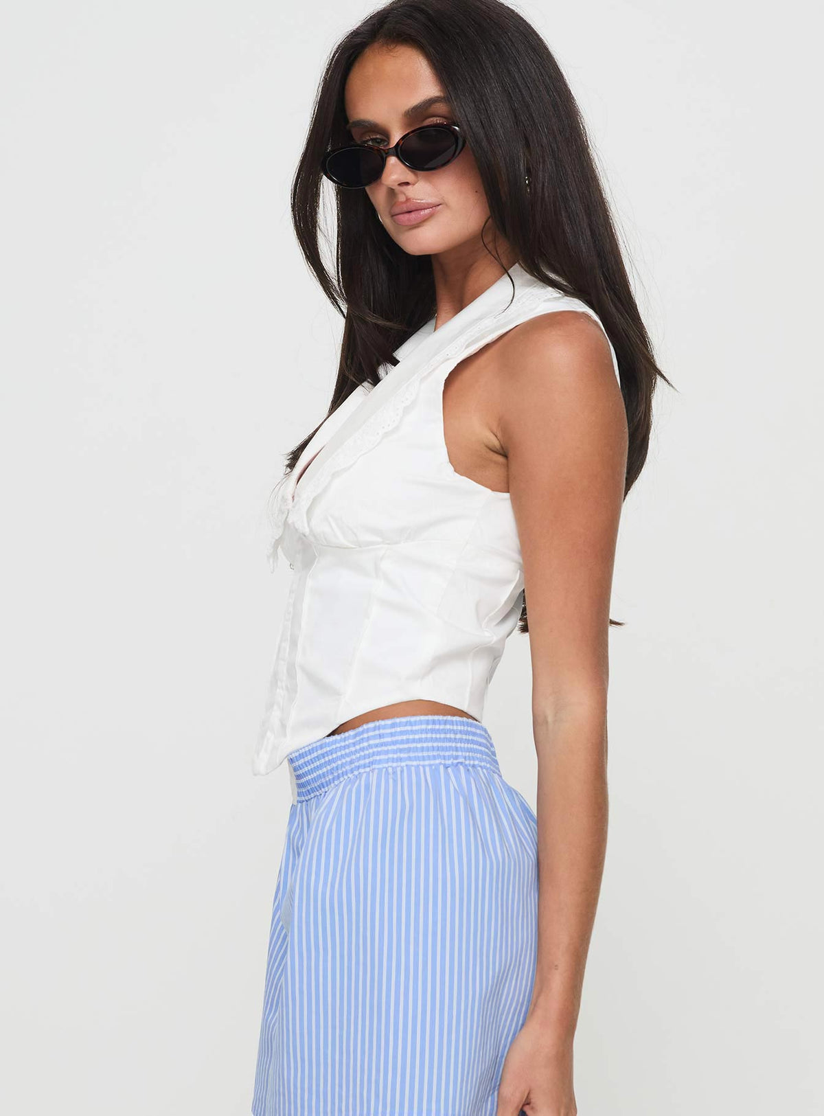 side view of model wearing Princess Polly Cophen Top White Sleeveless Plunger 