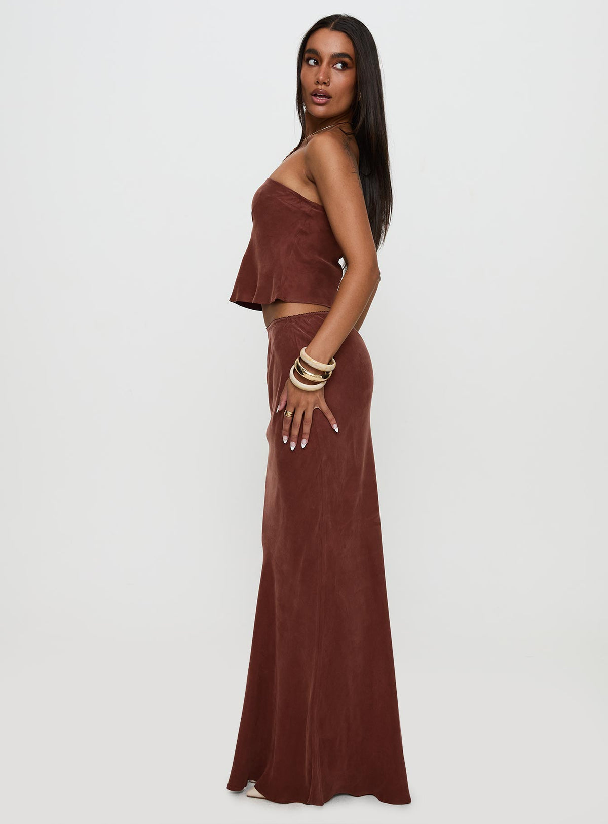  side view of model wearing Princess Polly Lucelia Maxi Skirt Brown Maxi 