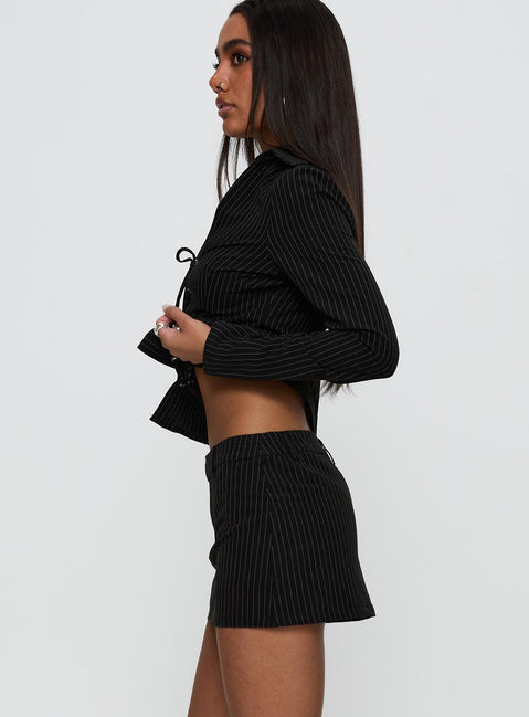 side view of model wearing Princess Polly Feminique Skort Black Stripe High Waisted Shorts 