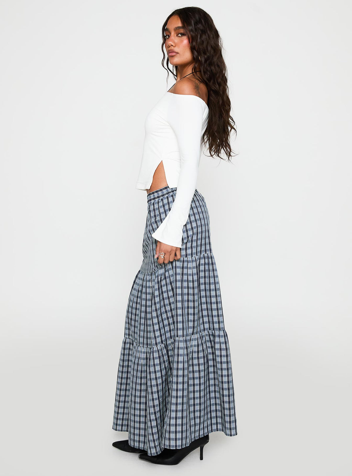   side view of model wearing Princess Polly Rockwell Tiered Midi Skirt Navy Check Maxi 