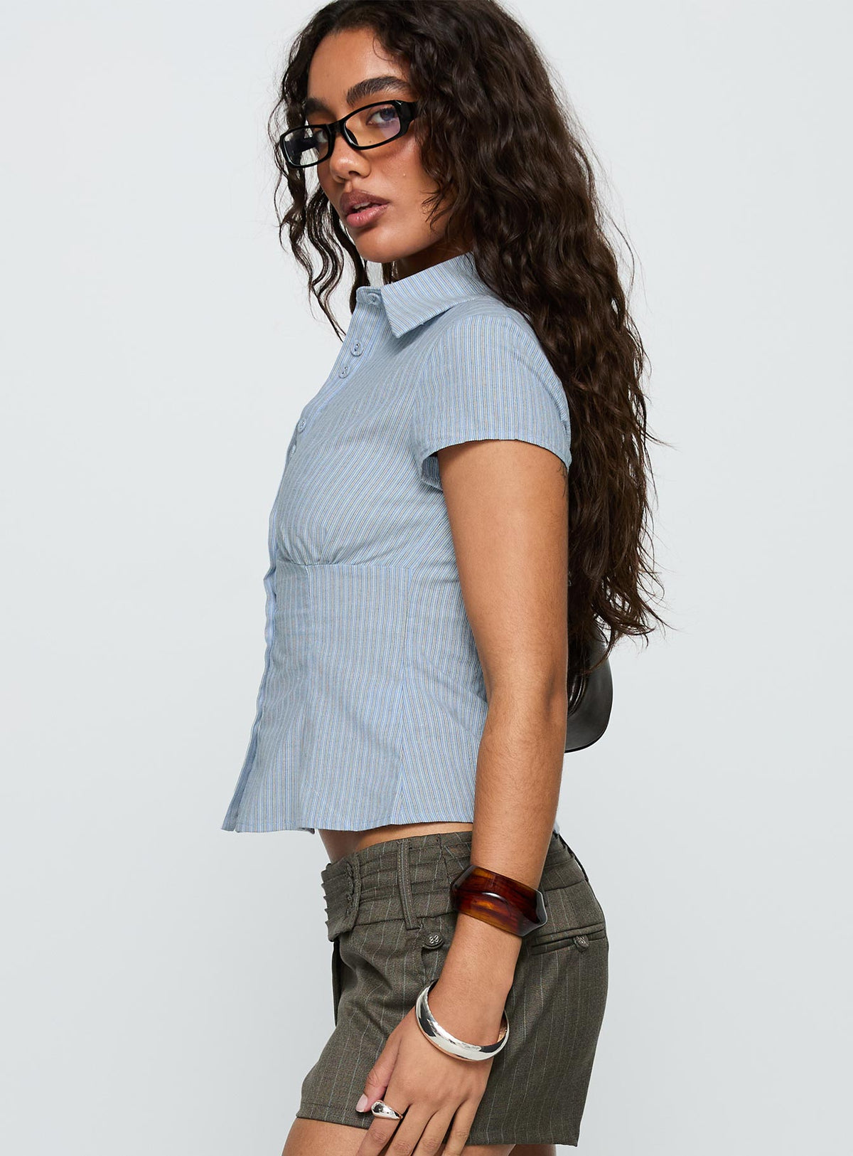 side view of model wearing Princess Polly Cottesloe Blouse Top Blue Stripe Short Sleeves V-Neck 