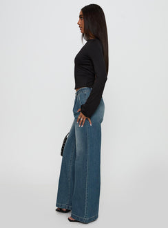 side view of model wearing Princess Polly Laguardia Mid Rise Wide Leg Jeans Dark Blue Wash Mid Rise Jeans Jeans 