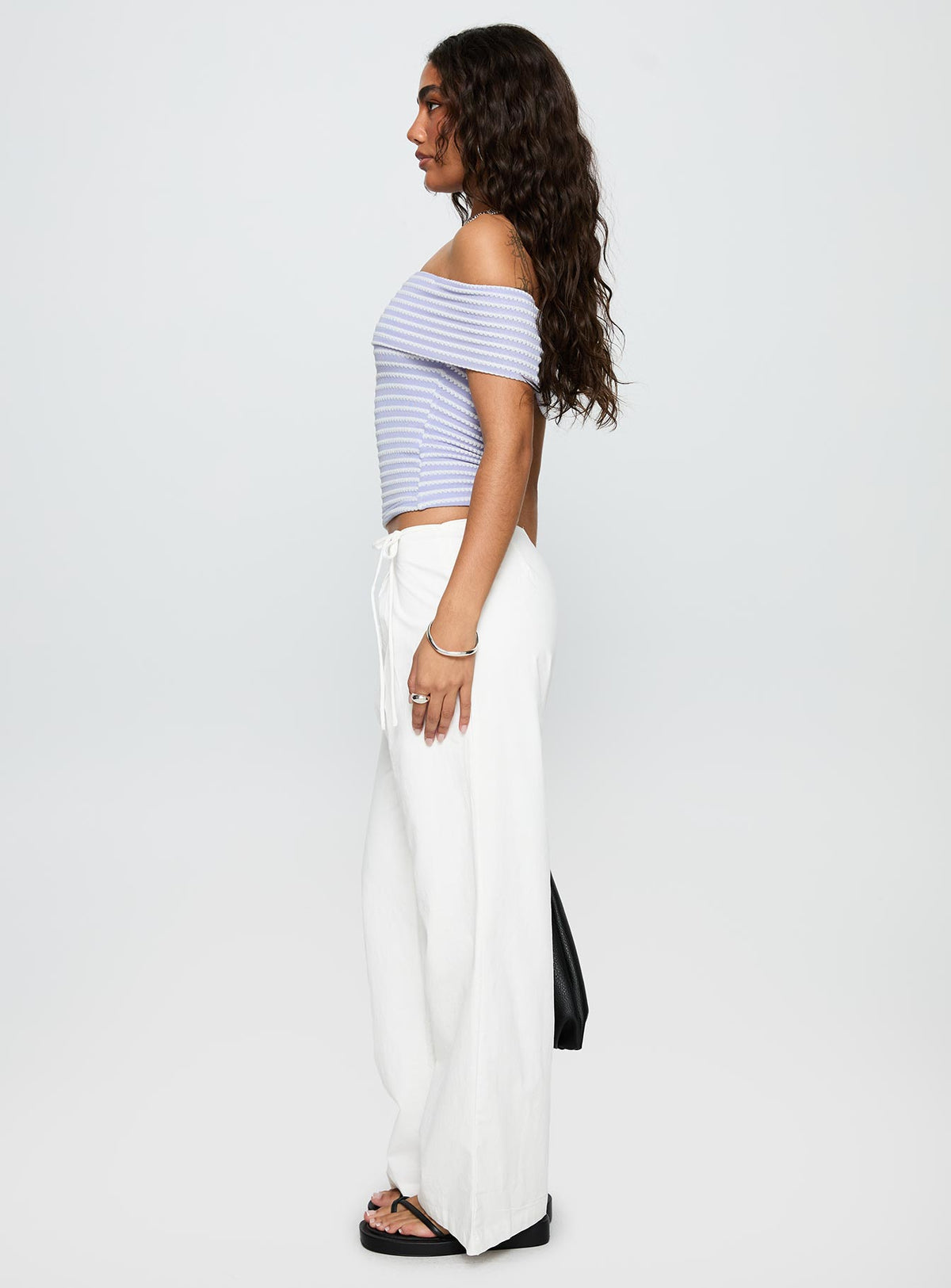 side view of model wearing Princess Polly Leyah Tie Side Pants White Low Rise Pants Pants 