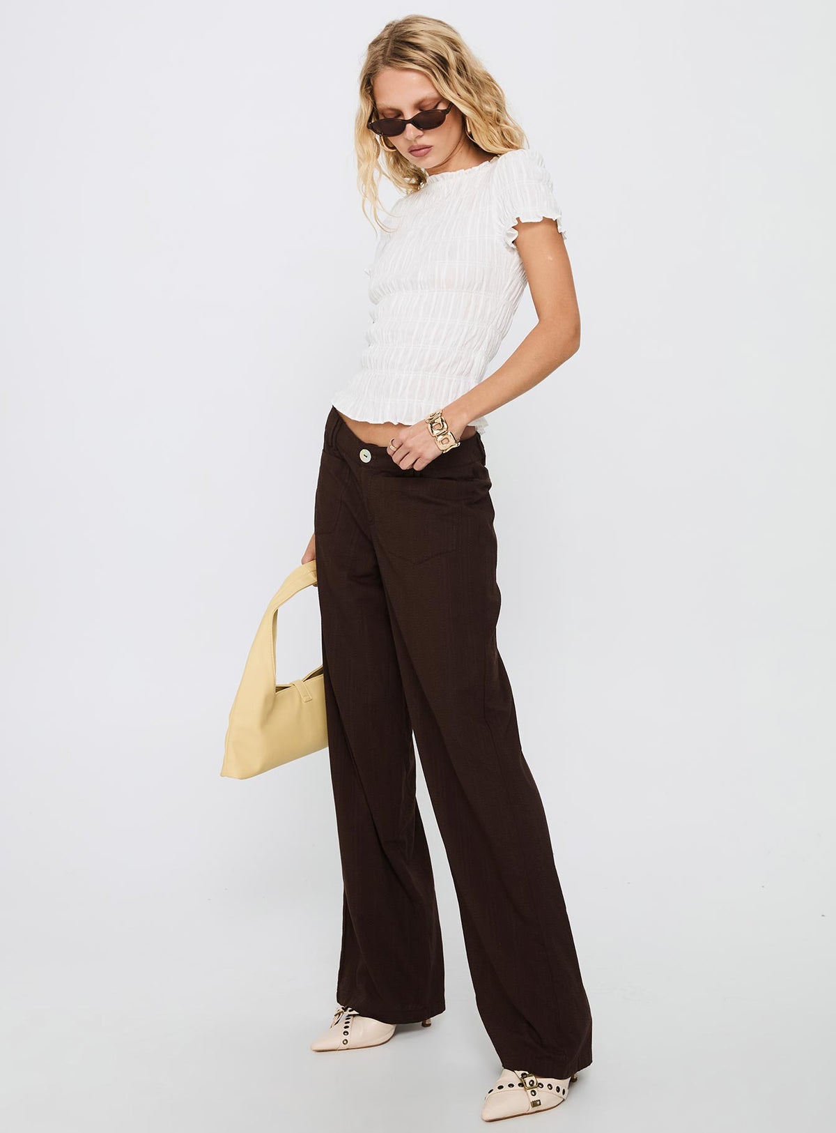 side view of model wearing Princess Polly Vendi Low Rise Pant Chocolate Low Rise Pants Pants 