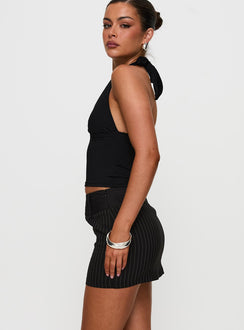   side view of model wearing Princess Polly Christel Pinstripe Skort Black Mini Skirts Skirts 