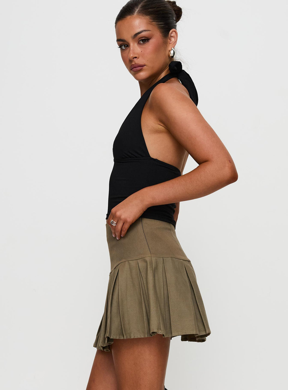   side view of model wearing Princess Polly Feodora Pleat Mini Skirt Khaki Mini Skirts Skirts 