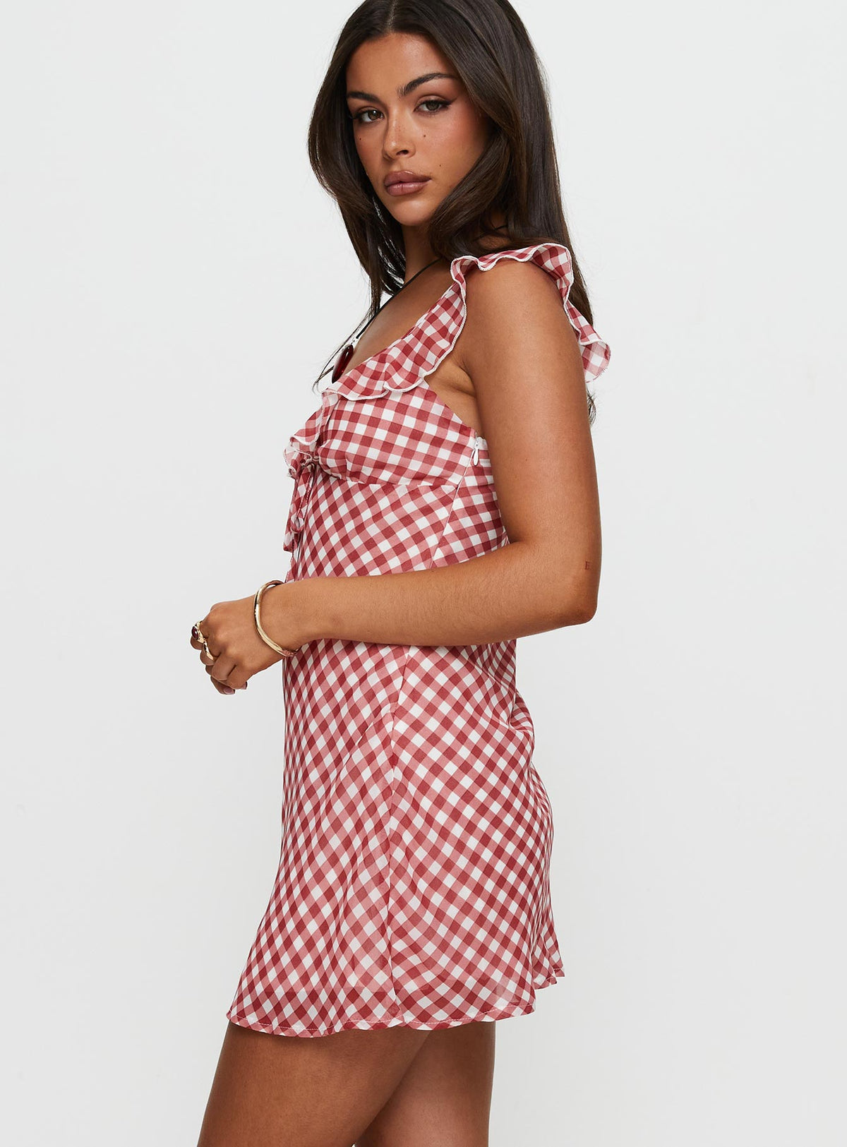 side view of model wearing Princess Polly Marseilla Mini Dress Red Check V-Neck 