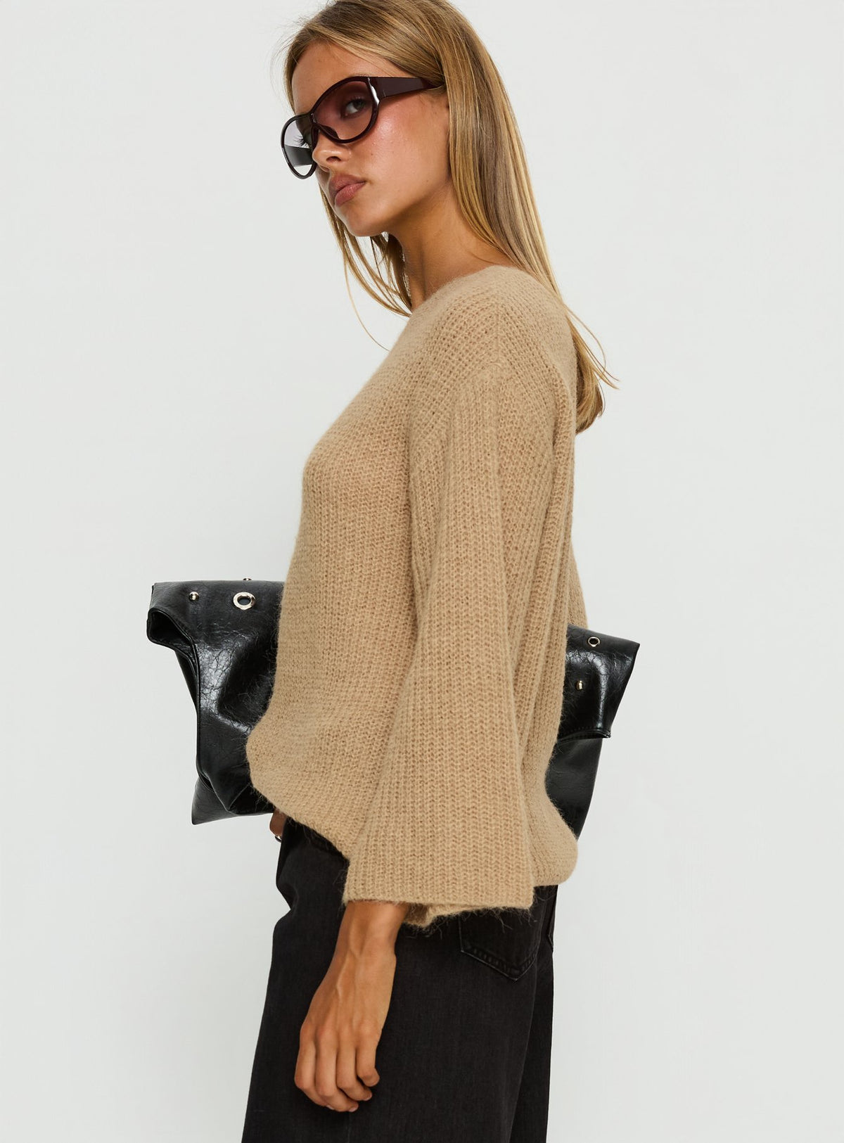 Designed with an oversized fit, the Delyn Off Shoulder Slouchy Knit Sweater Camel womens jumper in short length side view of model wearing Princess Polly