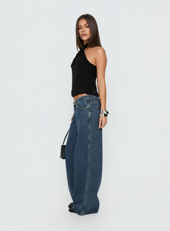 Featuring the Picco Ultra Low Rise Wide Leg Jeans Dark Blue Wash Petite in womens-jeans with low-rise waist side view of model wearing Princess Polly