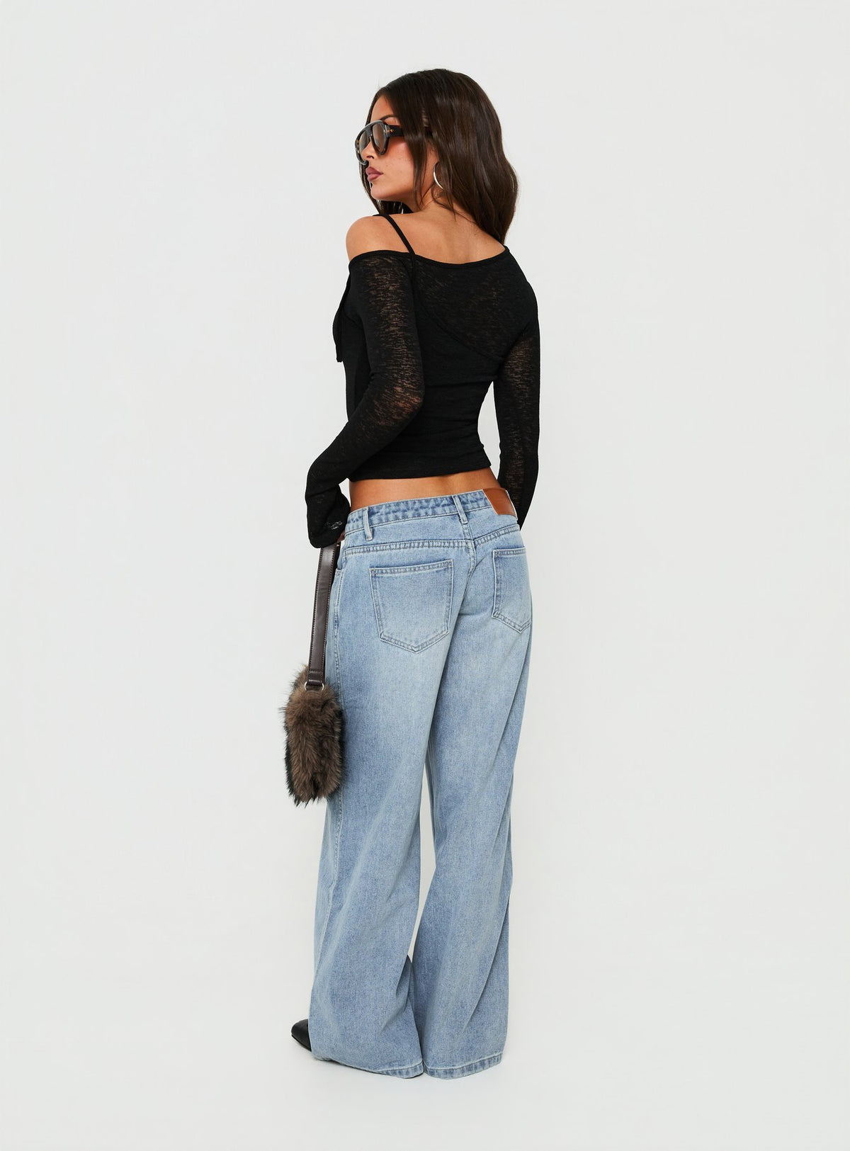Crafted with Picco Ultra Low Rise Wide Leg Jeans Light Blue Wash Petite in womens-jeans featuring a low-rise waistband back view of model wearing Princess Polly