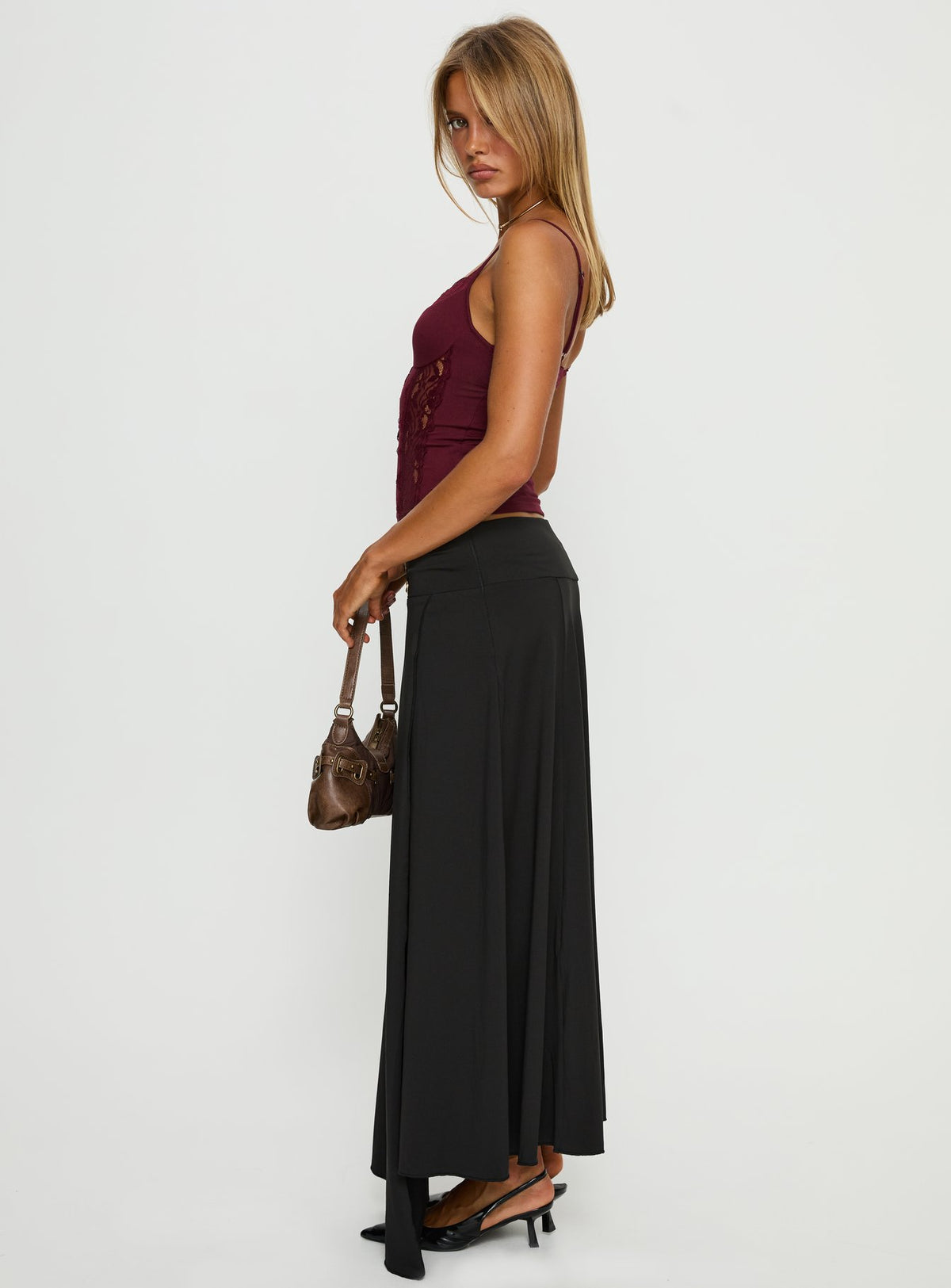   side view of model wearing Princess Polly Nola Hardware Slit Maxi Skirt Black Skirts 