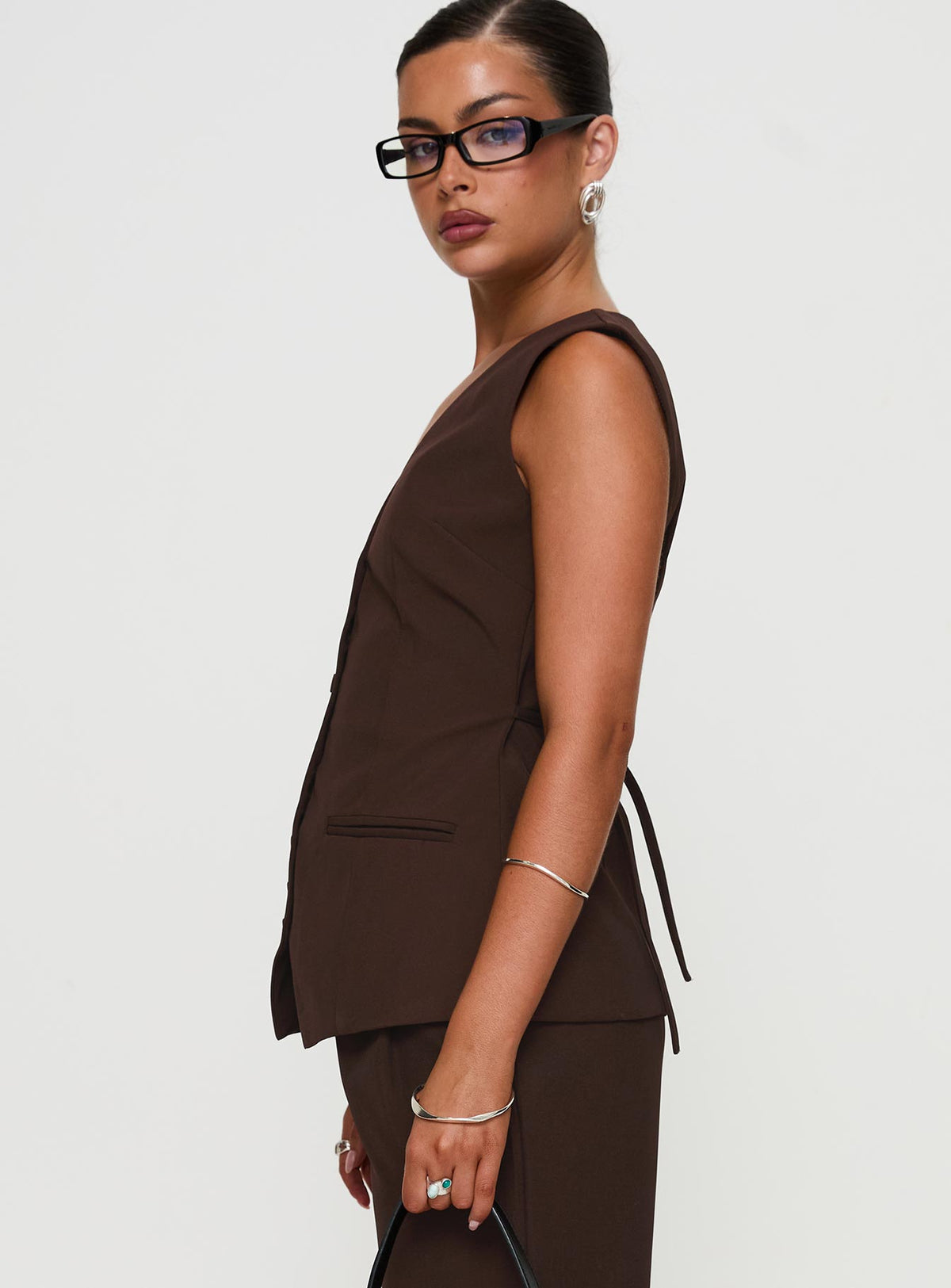 side view of model wearing Princess Polly Ambient Longline Button Up Top Chocolate Sleeveless V-Neck 