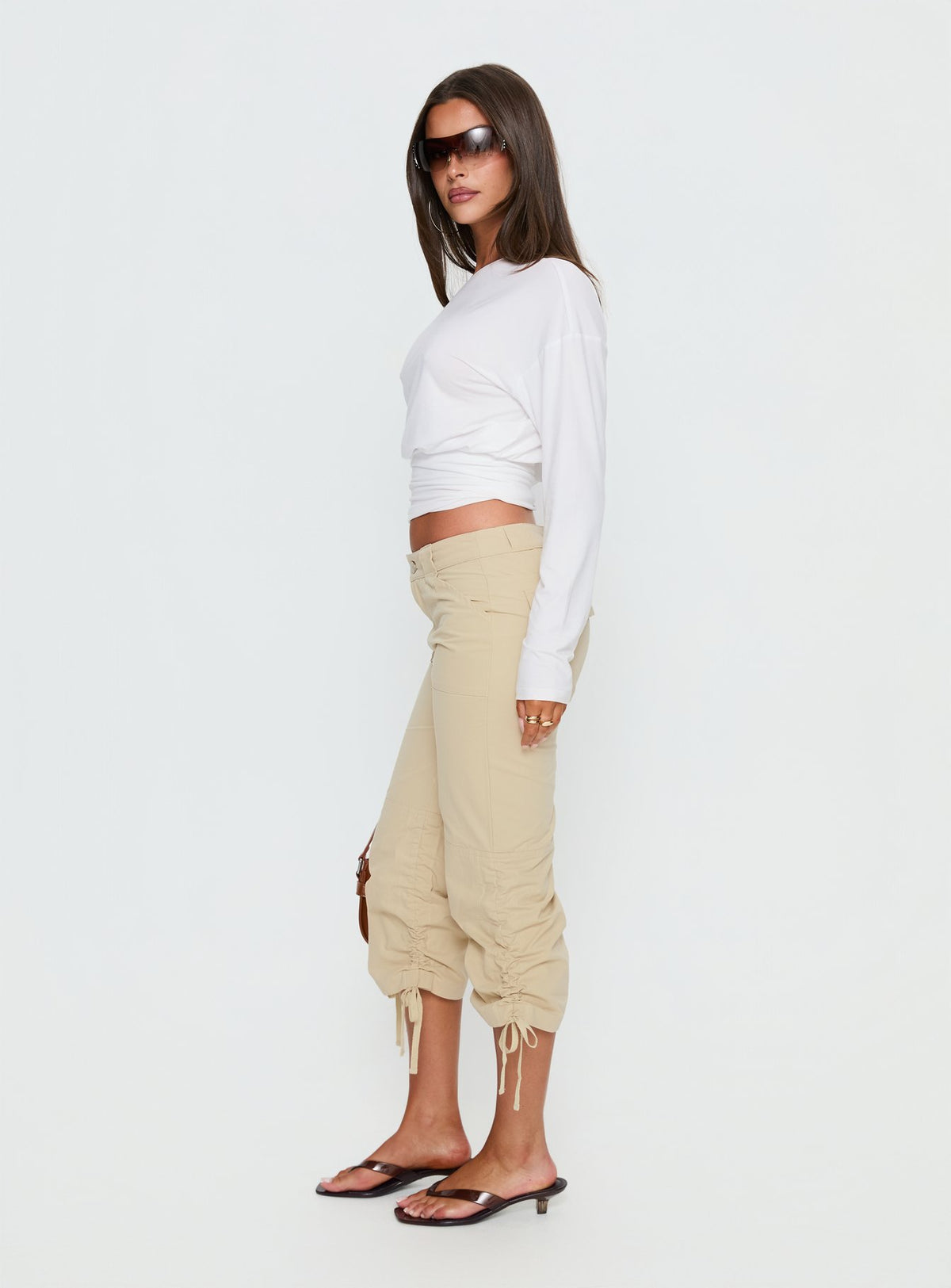 side view of model wearing Princess Polly Hot Rod Capri Pant Beige Mid Rise Pants Pants 
