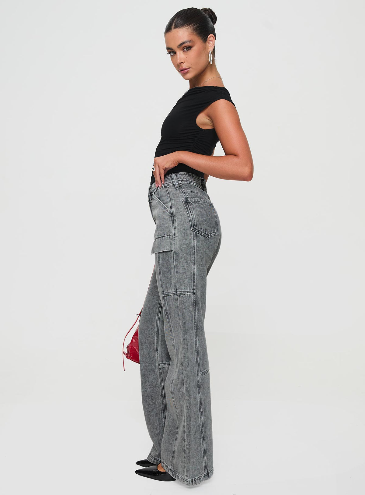 side view of model wearing Princess Polly Chad High Rise Flared Cargo Jeans Washed Grey Mid Rise Jeans Jeans 