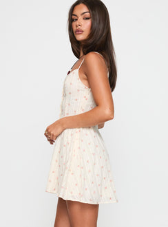 side view of model wearing Princess Polly Toulouse Mini Dress Cream / Floral Scoop Neck 